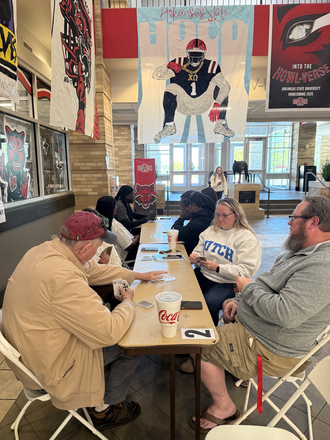 Veterans and students playing Grunt Spades at a table at Arkansas State University